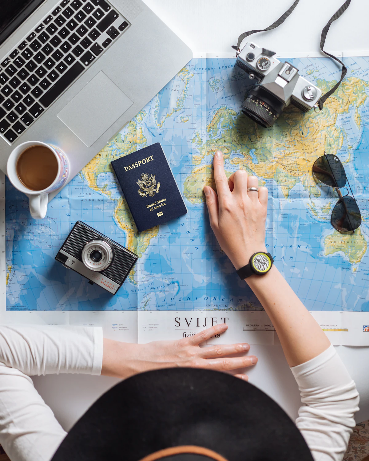 Travel map, passport and camera arranged for holiday planning