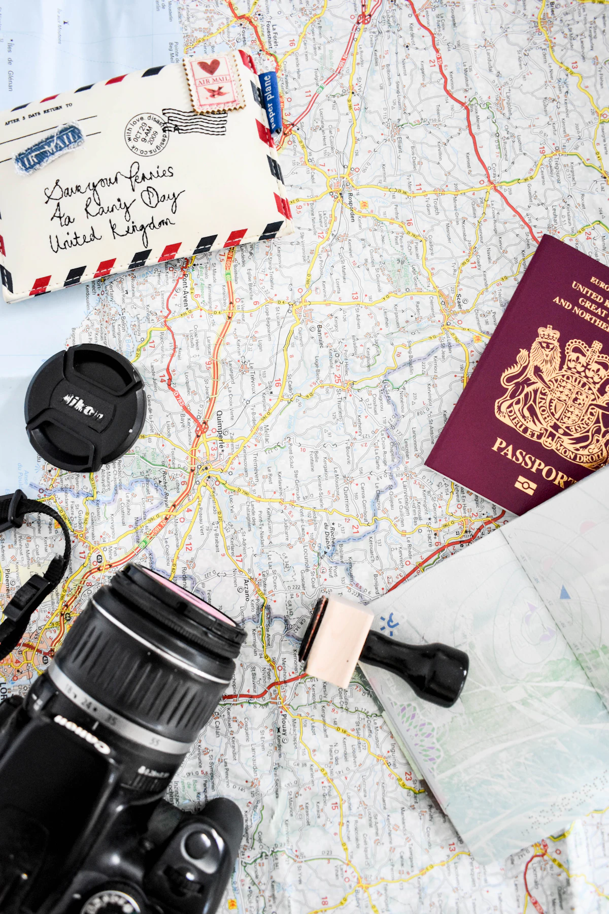 Passport, camera and map prepared for travel planning
